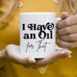 woman in yellow shirt holding a mug that says I Have an Oil For That essential oil mug