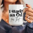 woman holding an I Have an Oil for That essential oil mug