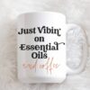 image of essential oil mug on white fur. Just Vibin on Essential Oils and coffee
