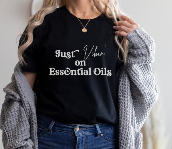 woman wearing black t shirt that says just vibin on essential oils