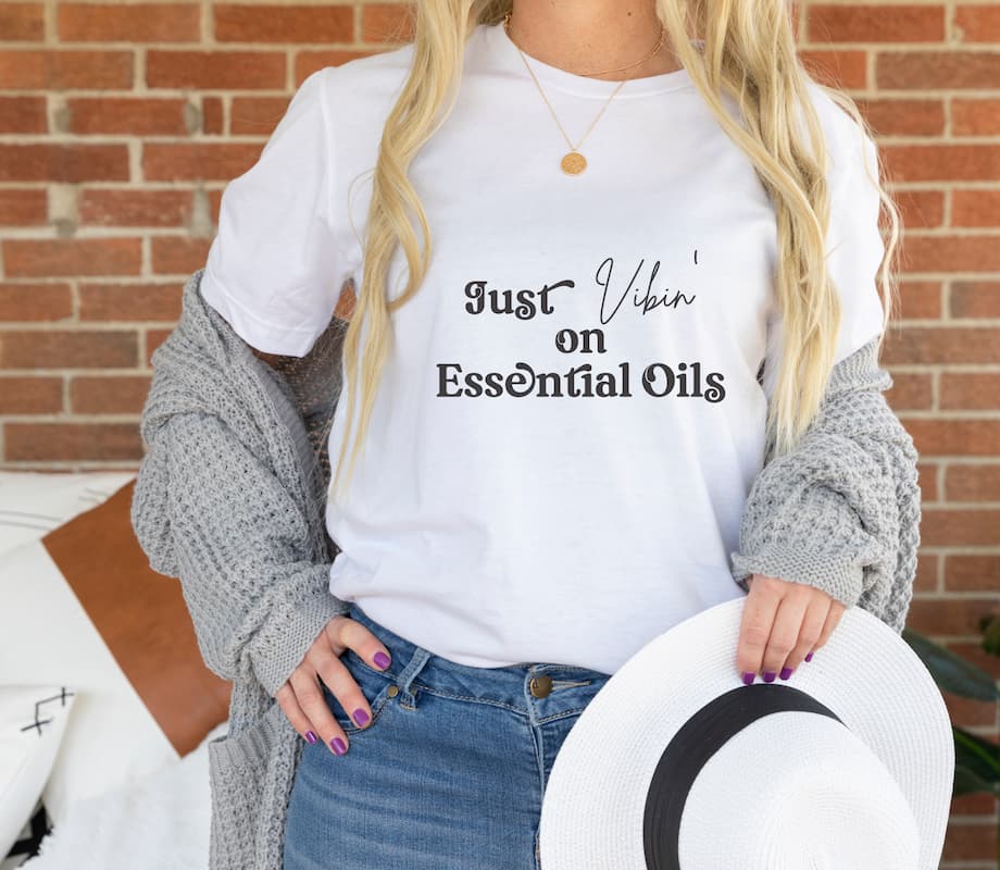 woman wearing just vibin on essential oils white t shirt