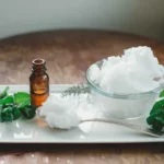 jar of coconut oil with bottle of essential oil for oil pulling