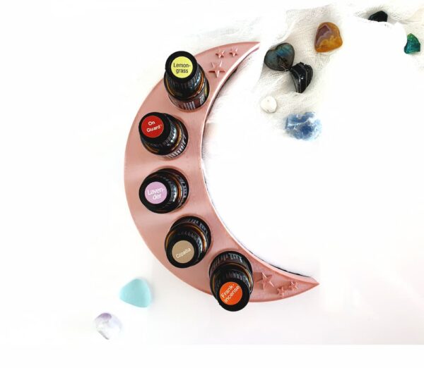white background with gemstones and rose gold crescent moon essential oil stand