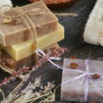 bars of homemade essential oil soap with dried flowers and coffee beans