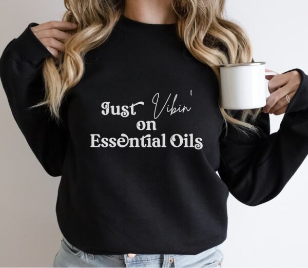 woman modeling just vibin on essential oils sweatshirt