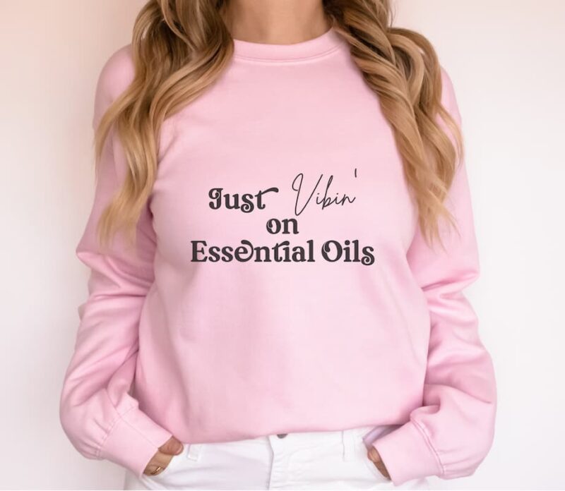 woman modeling pink just vibin on essential oils sweatshirt