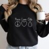 woman wearing peace love oils essential oil sweatshirt