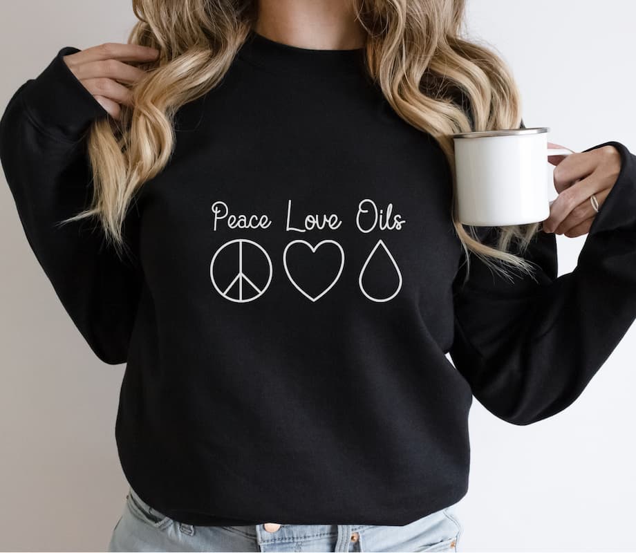 woman wearing peace love oils essential oil sweatshirt