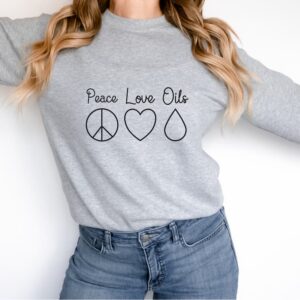 woman wearing grey peace love oils essential oil sweatshirt