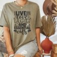 woman wearing olive colored tee with text that says I love on love laughter and essential oils