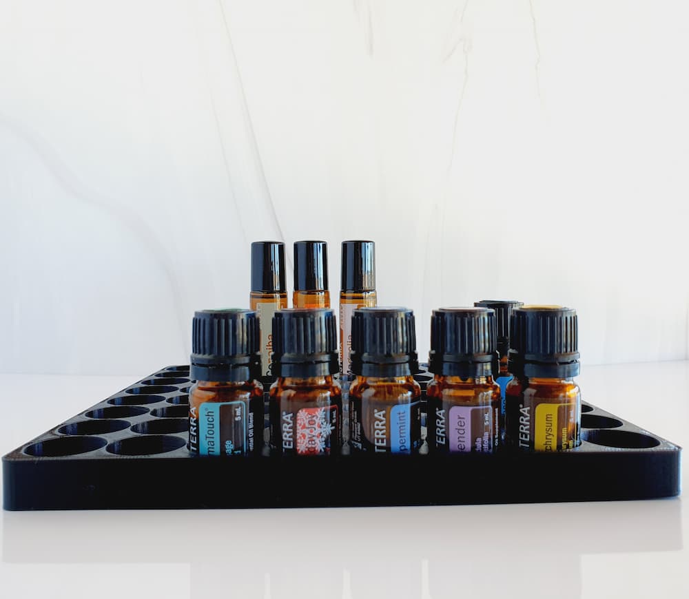 white background with side view photo of essential oil storage display with doTERRA bottles and rollers in it