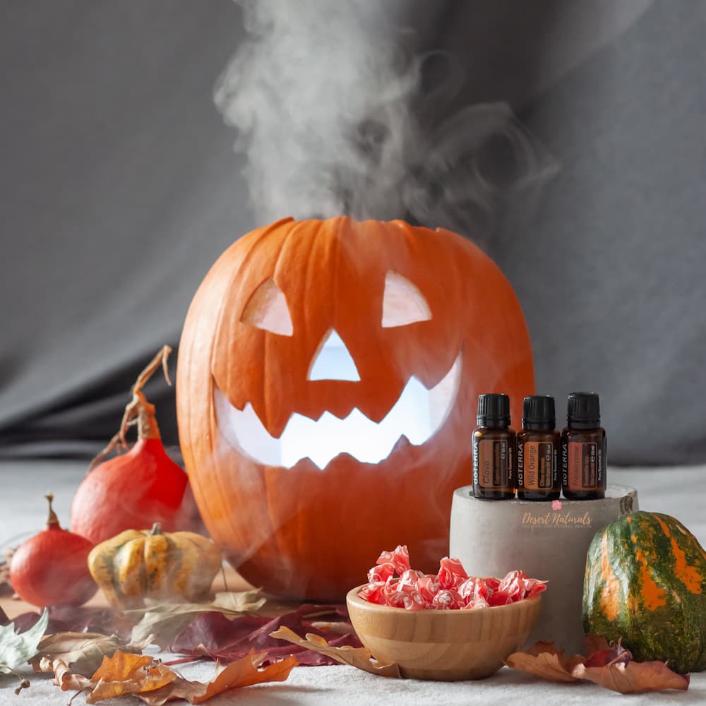 image of pumpkin with a diffuser inside of it and 3 doTERRA essential oil bottles