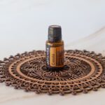 image of bottle of doTERRA Cassia essential oil on wooden mandala