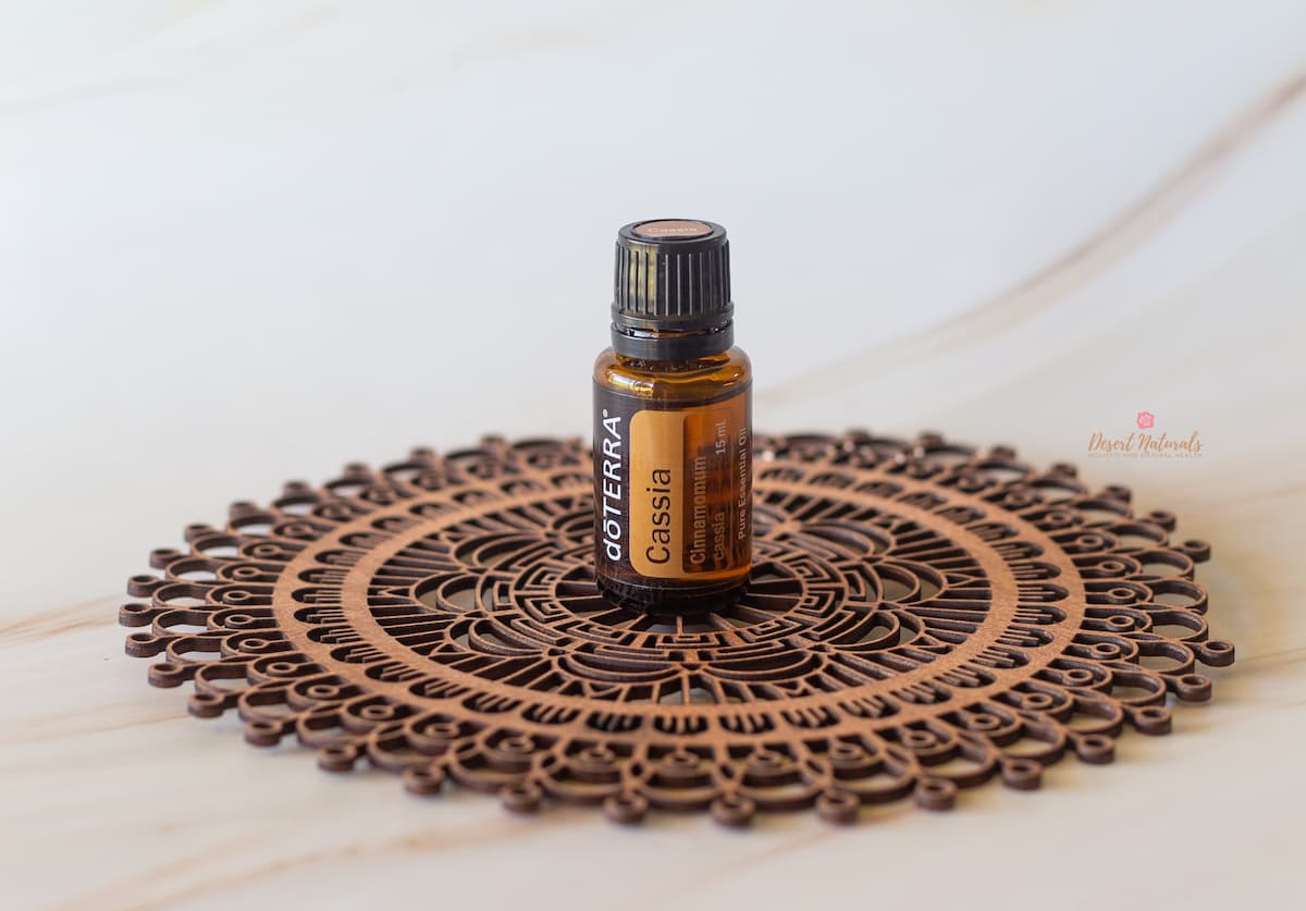 image of bottle of doTERRA Cassia essential oil on wooden mandala