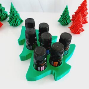 white background with green Christmas Tree essential oil stand and doterra bottles