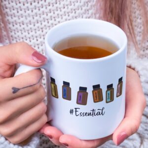 Ceramic essential oil bottle mug in the hands of a woman
