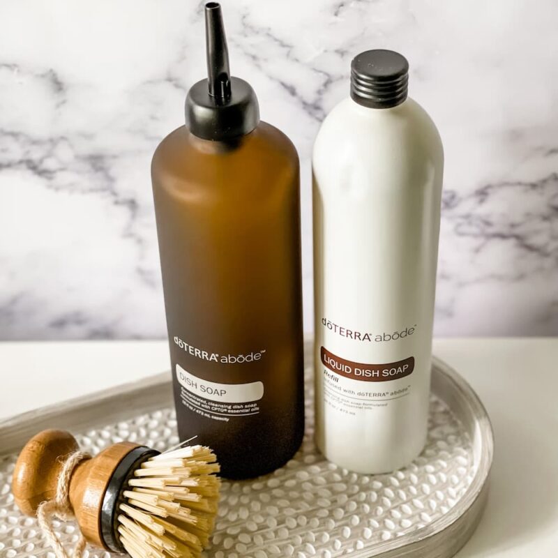 abode dish soap and refill-447-193440 (1) image of doterra abode dish soap refill, glass dispenser and bubble up brush on tray