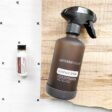 photo of doTERRA multi purpose cleaner concentrate on a towel with a spray bottle on wood