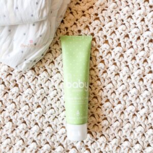 photo of doterra baby diaper rash cream on minimalist background with natural diaper