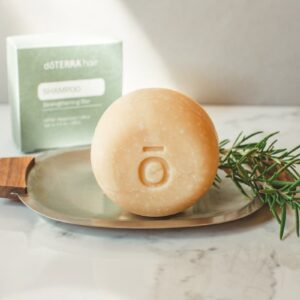 photo of the doterra shampoo bar with a sprig of rosemary