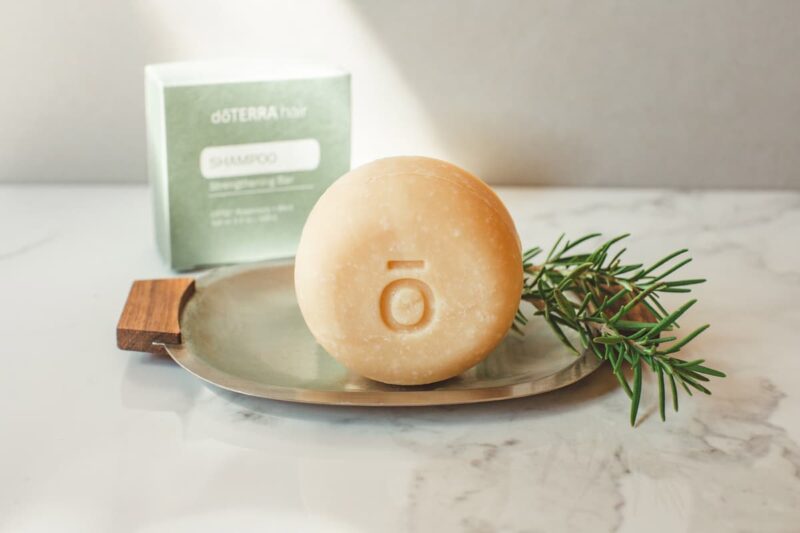 photo of the doterra shampoo bar with a sprig of rosemary