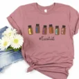 doterra essential oil bottle tee with denim shorts and flowers on a white background