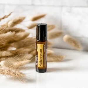 boho style image of doTERRA Helichrysum Touch 10ml roller on white counter.