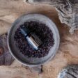 rustic photo of doTERRA Myrrh essential oil in bowl on wood surface