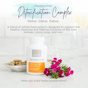 photo of bottle of doTERRA Zendocrine detox complex with capsules in a bowl and flower accents