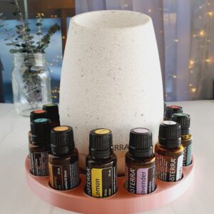 photo of rose gold round essential oil diffuser stand with doTERRA bottles