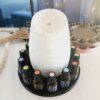 Round essential oil diffuser holder stand in black with doTERRA oils.