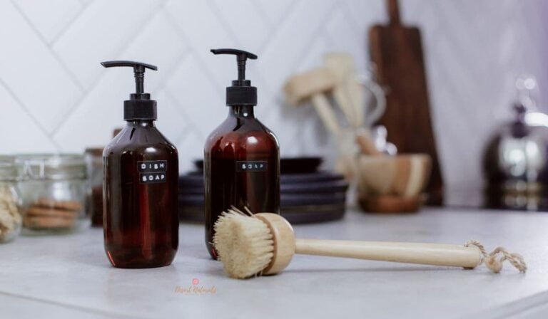 homemade dish soap bottle on counter with cleaning brush