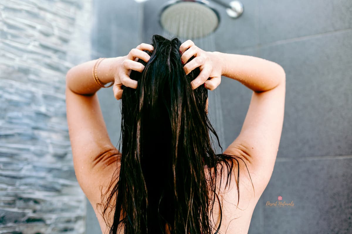 woman in shower applying diy hair mask