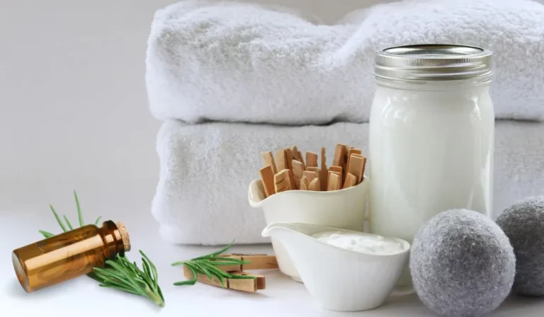 diy laundry detergent in mason jar with essential oil. folded towels in background