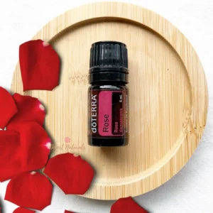 doTERRA Rose Essential oil with rose petals on wood