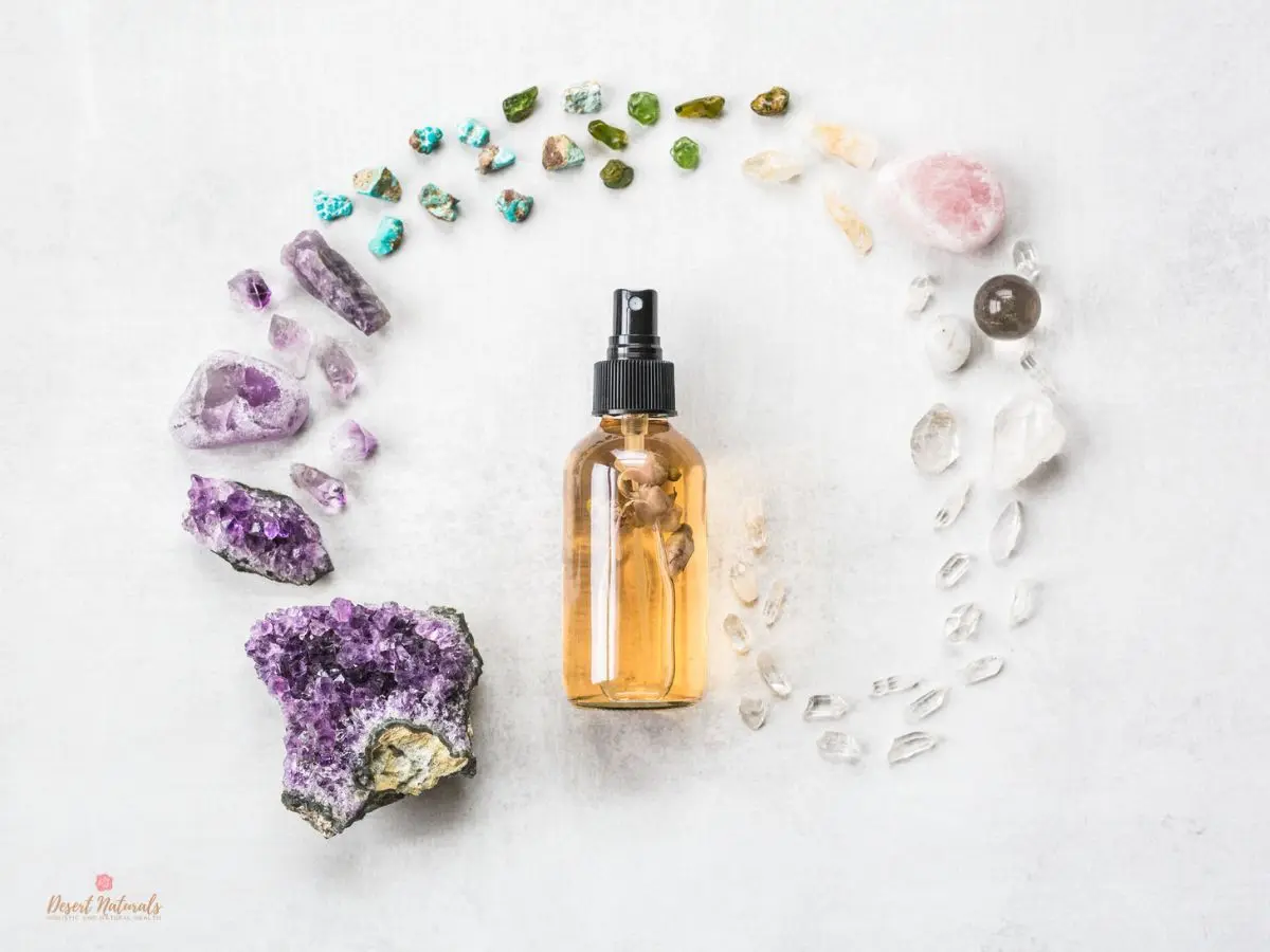 spray bottle for diy essential oil face toner with pretty crystals around it