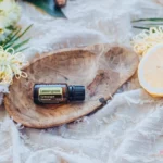 bottle of doterra lemongrass essential oil in a wood bowl