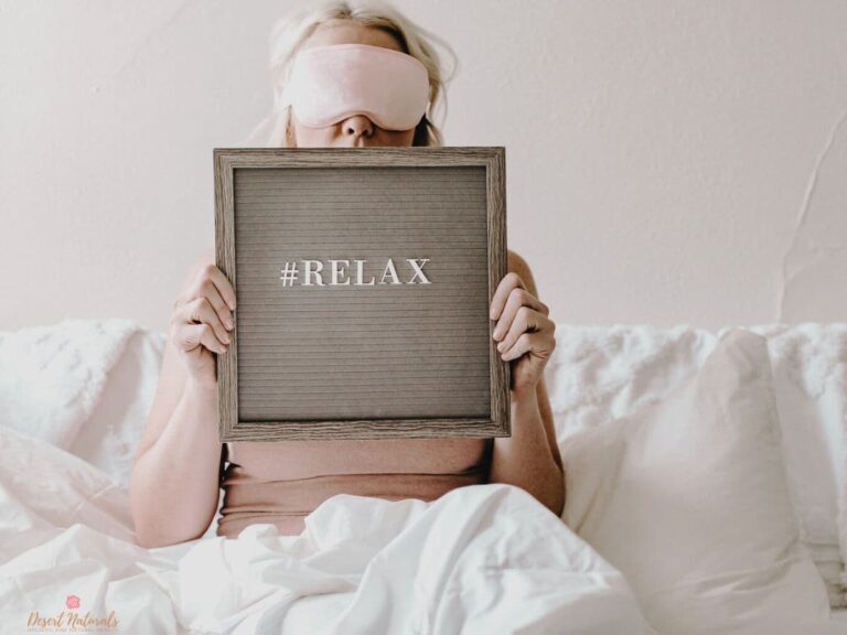 woman in bed with eye mask and relax sign for better sleep