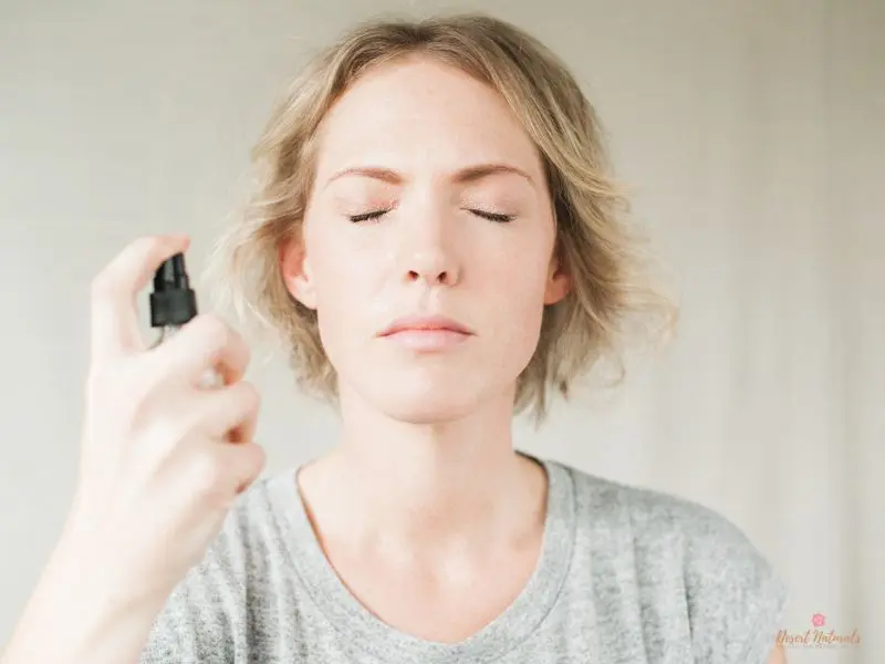 woman using a diy essential oil face toner