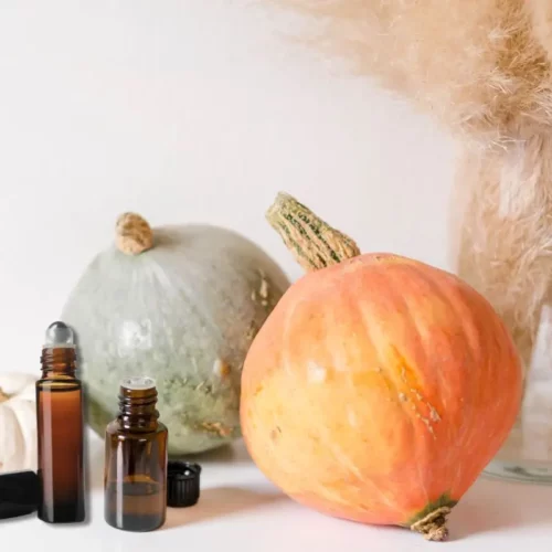essential oil bottle and roller with fall pumpkins