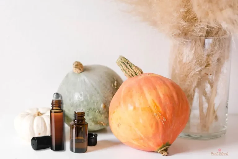 essential oil bottle and roller with fall pumpkins
