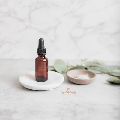 bottle of essential oil face serum on tray