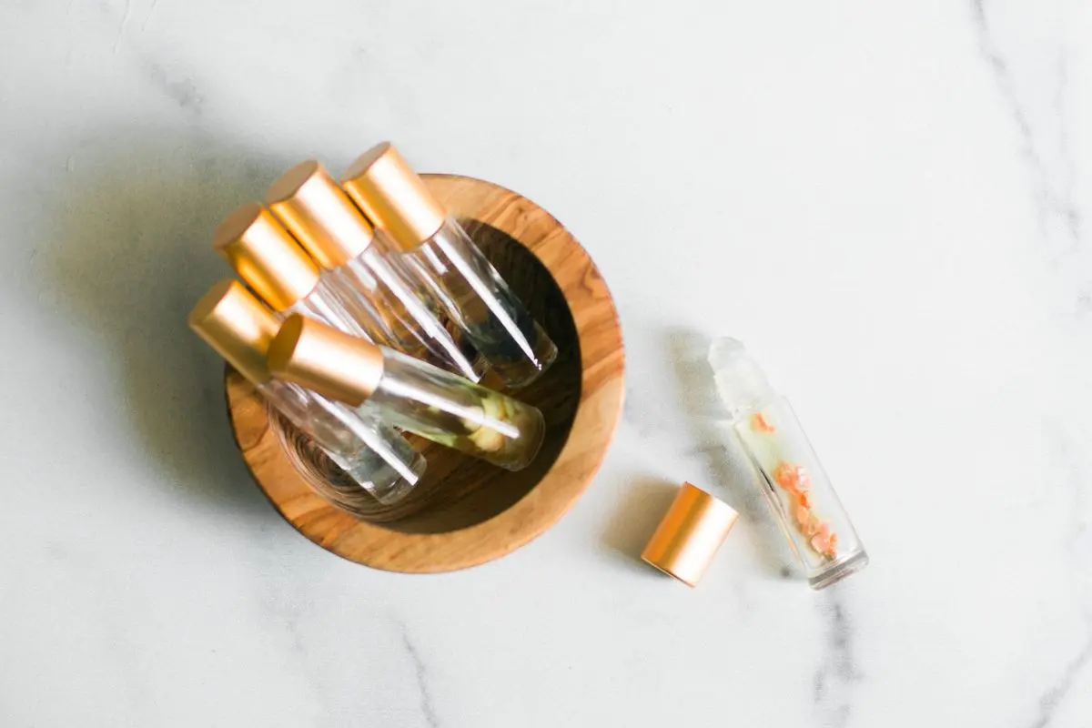 calming essential oil rollerballs in a wood bowl