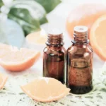 essential oil bottles and grapefruit for cellulite