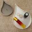 doterra oil drop trinket tray with oil bottle and roller in it