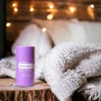 photo of doTERRA Serenity sleep Stick on wood nightstand with cozy bed and blanket