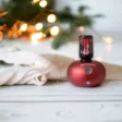 image of doterra ruby bubble diffuser with holiday joy essential oil on a Christmas background