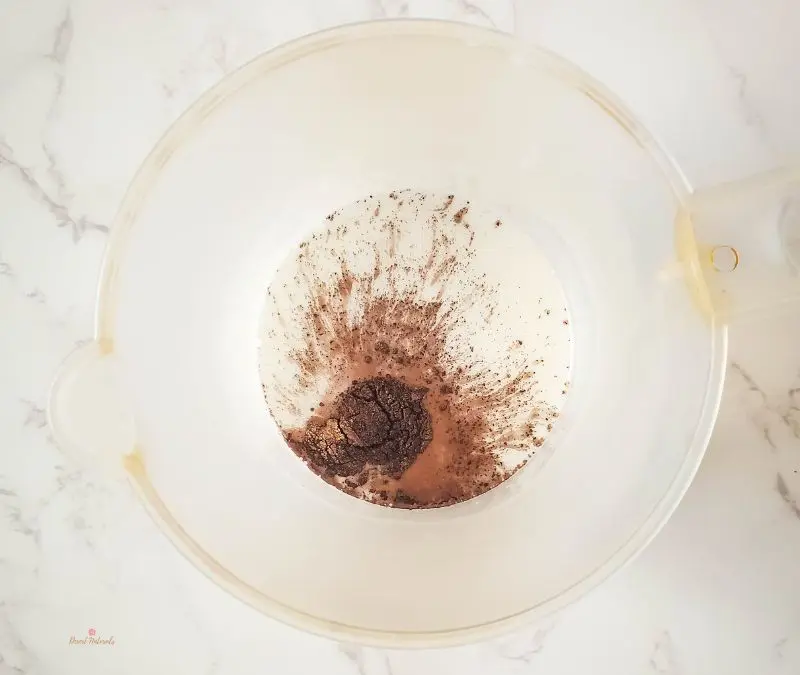 bowl of melted soap base with brown micah powder for making gingerbread soap bars