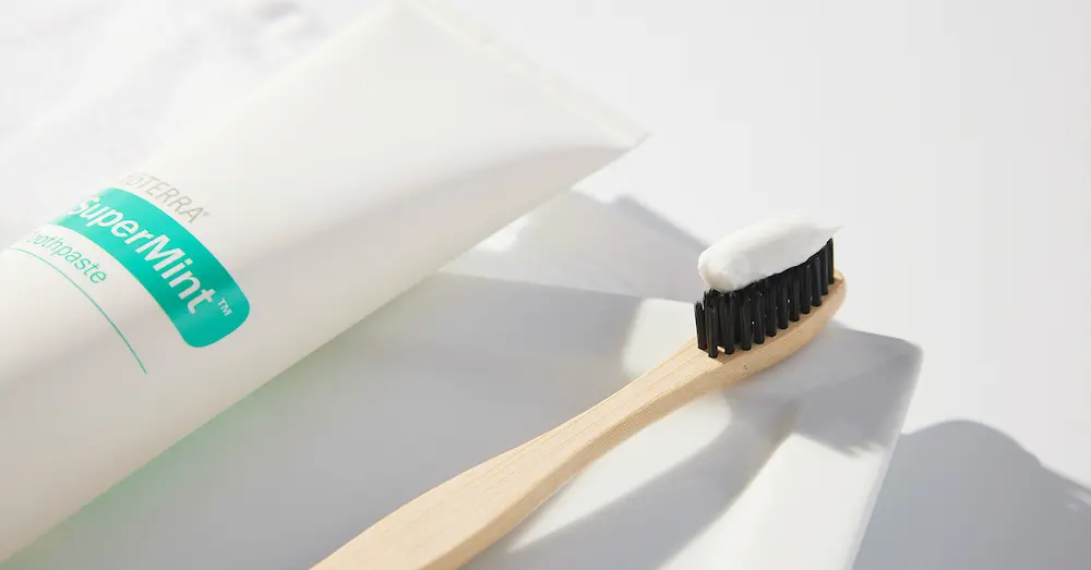 photo of doTERRA Supermint toothpaste with a toothbrush