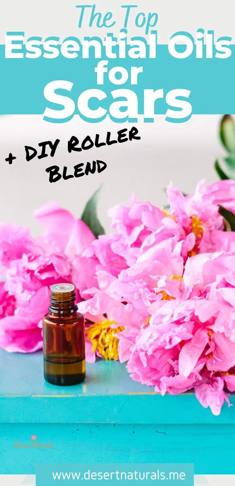 image of essential oil bottle with pink flowers and text top essential oils for scars + diy roller blend